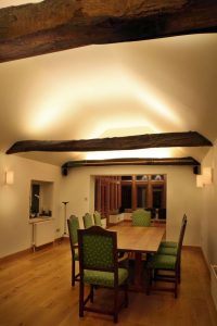 Diningroom lighting with beams by Sam Coles Lighting