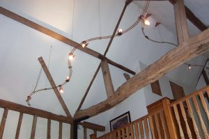 Copper lighting track in listed barn