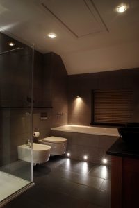Bathroom with floor wash wall lighting