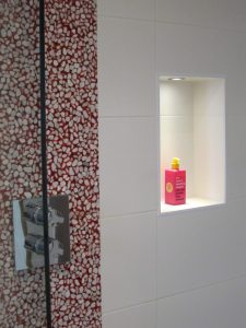 Illuminated niche in bathroom wall